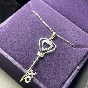 Zales 1/10 CT. T.W. Diamond "XO" Heart-Top Key Pendant in Sterling Silver